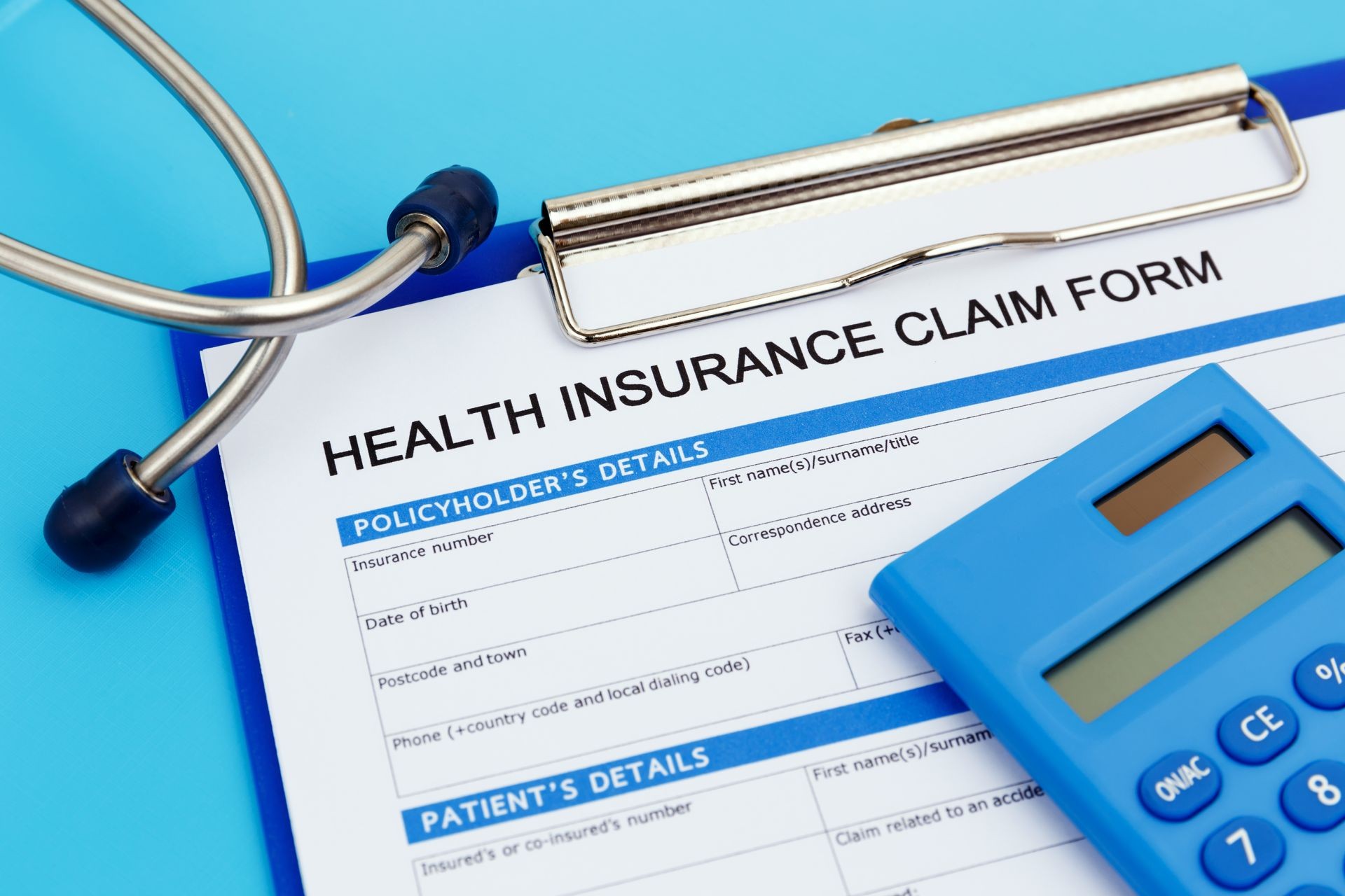 Health insurance claim form with pen and stethoscope